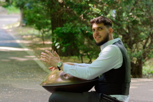 Boy playing music with a handpan